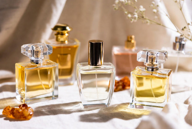 Everyday Arabian perfumes arranged with soft fabric oud wood and warm premium details for Soghaat fragrance guide