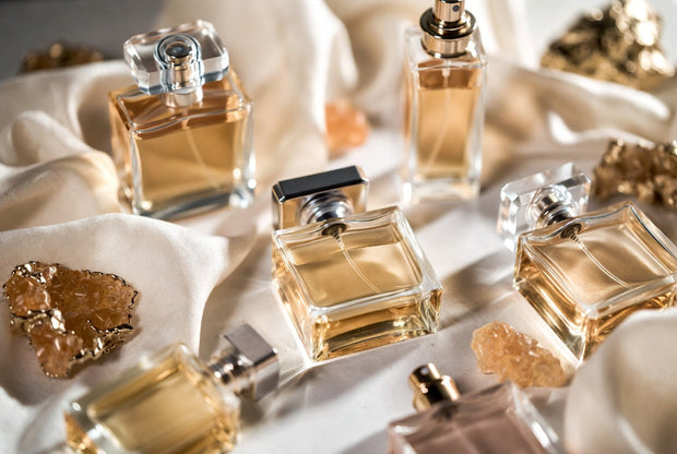 Inspired perfume bottles arranged with warm premium details for a Soghaat guide on choosing inspired fragrances