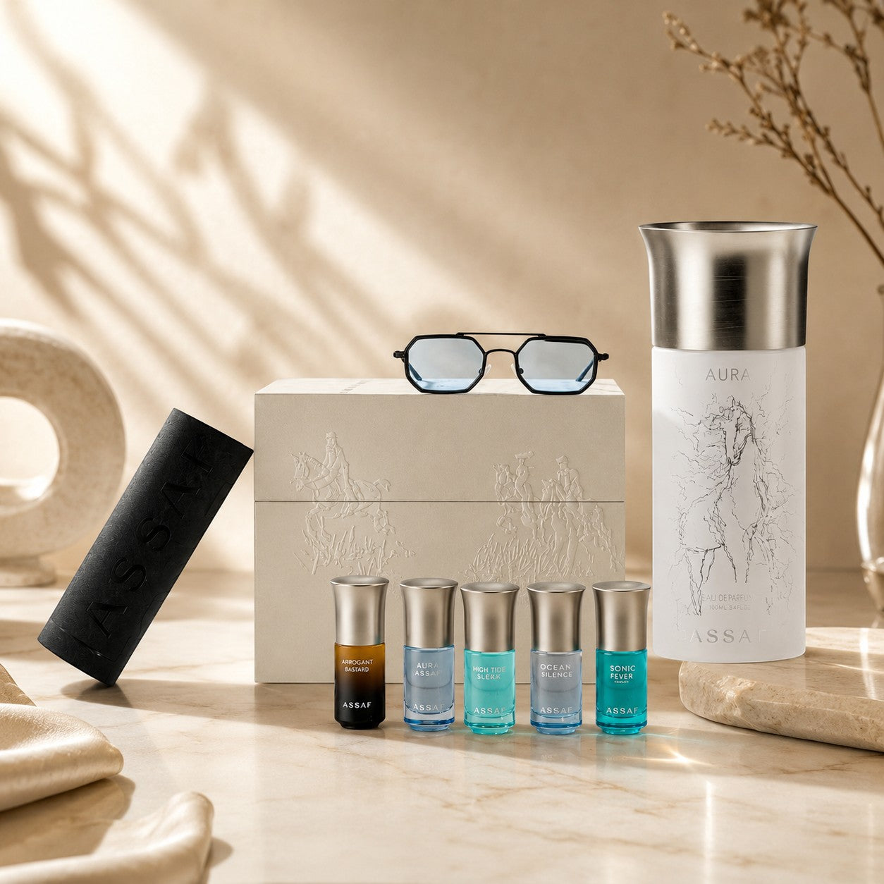 Assaf Aura Collection & Sunglass Gift Set: Aura Pegasus perfume, 5 mini Arrogate perfumes, and blue-tinted sunglasses.