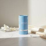 Osma White F Eau de Parfum by Osma, a sweet gourmand fragrance in a light blue cylindrical bottle with silver accents.