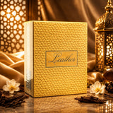 Soghaat Ahmed Al Maghribi Leather 50ml Eau de Parfum box with gold textured finish, surrounded by jasmine and wood.