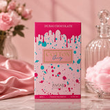 Soghaat Anfar Cotton Candy Extrait de Parfum box with pink drip design, displayed with pink roses and cotton candy.