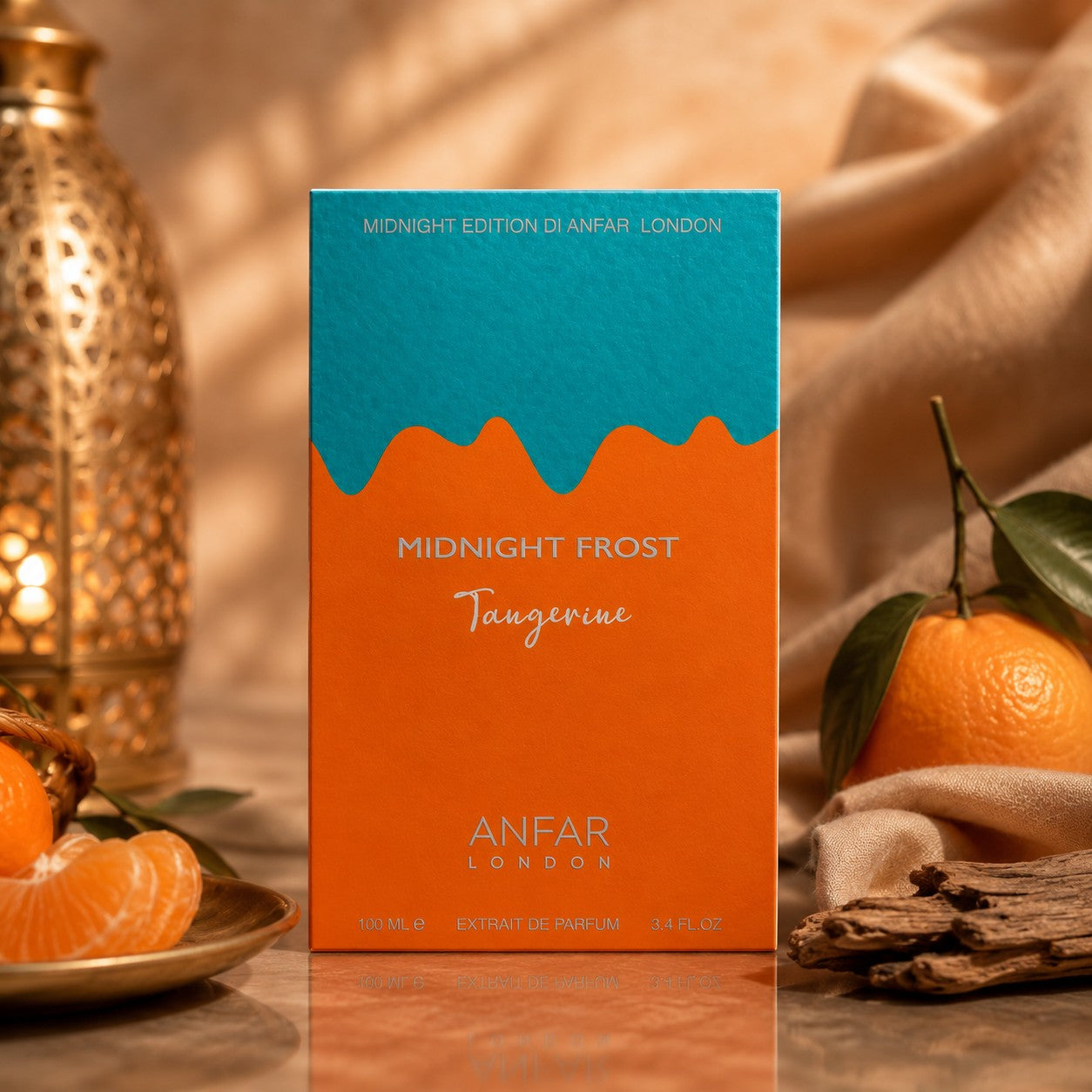 Soghaat Anfar London Midnight Frost Tangerine perfume box with orange and teal design, fresh tangerines, and driftwood.