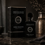 Soghaat Anfar London Nero Velours Extrait de Parfum in a black velvet bottle and matching box on a marble surface.