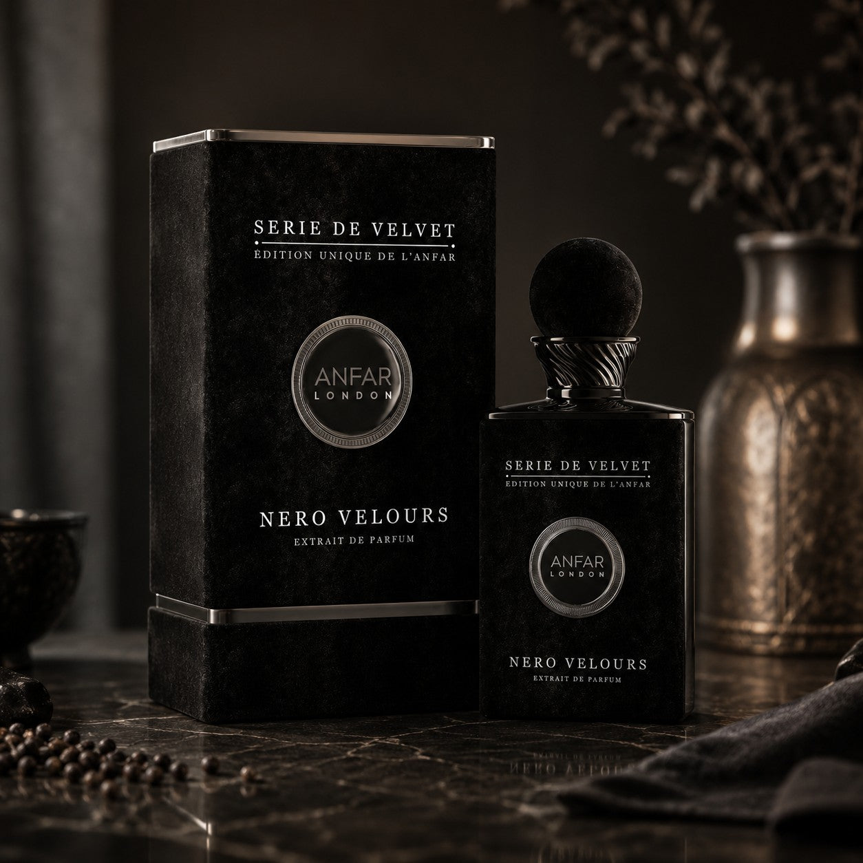 Soghaat Anfar London Nero Velours Extrait de Parfum in a black velvet bottle and matching box on a marble surface.