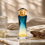 Soghaat Ahmed Al Maghribi Aqua Oud Eau de Parfum in a blue-to-yellow gradient glass bottle with an ornate gold cap.
