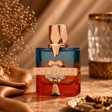 Soghaat Aromatix Teas Me Extrait de Parfum, a gradient glass bottle with blue top and red bottom, gold accents.