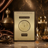 Soghaat Artisan Oud by Anfar 100ml Extrait de Parfum box with gold emblem, incense, and perfume bottle on marble.