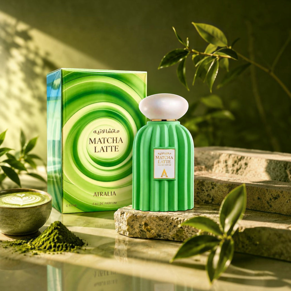 Soghaat Atralia Matcha Latte unisex Eau de Parfum bottle and green swirl box on stone with matcha tea and leaves