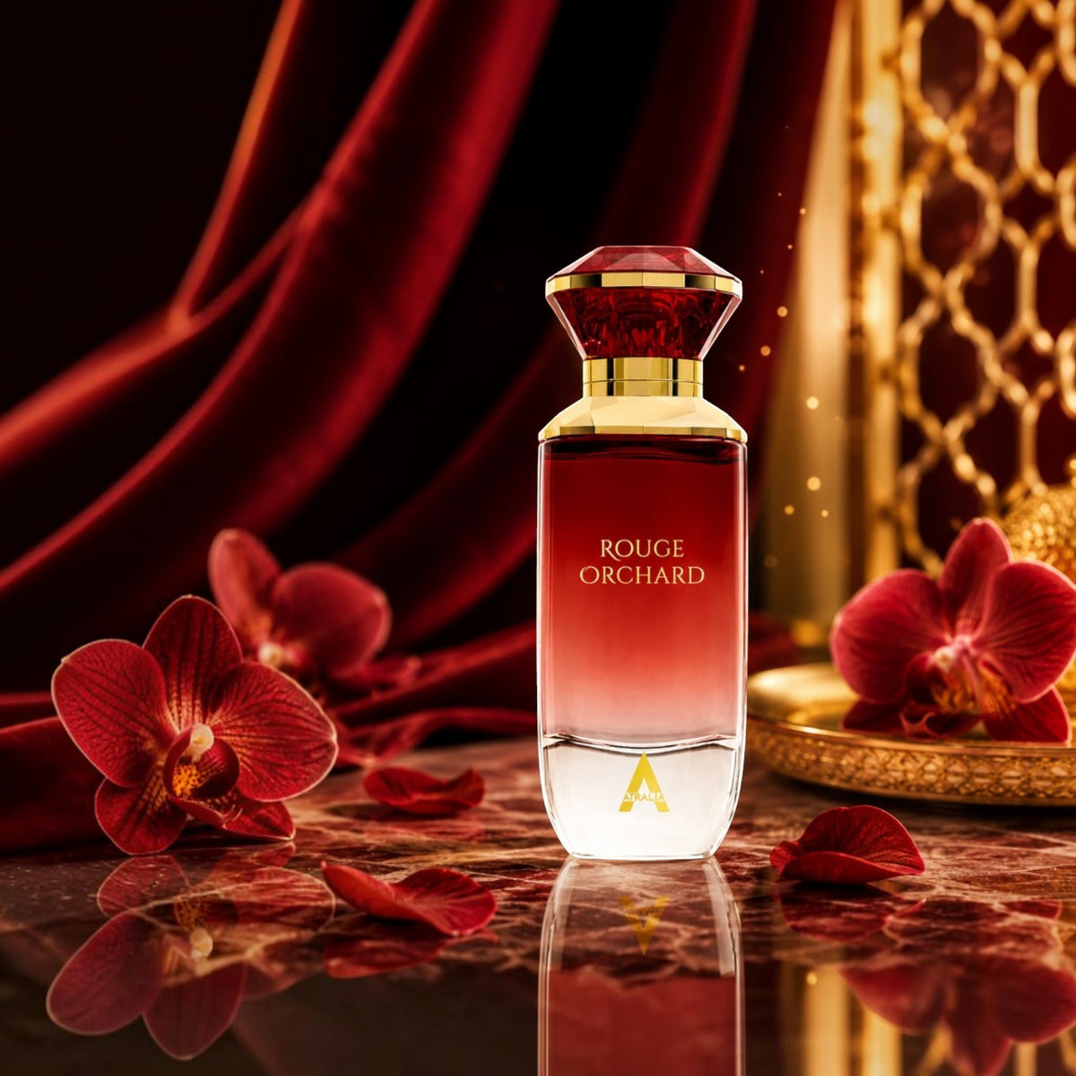 Soghaat Atralia Rouge Orchard Eau de Parfum bottle with red orchids on a marble surface against a velvet backdrop.