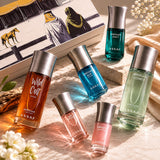 Assaf Bakhur Collection perfume gift set with six bottles in amber, blue, green, and pink glass. Includes Arrogate Wild Colt, Comete, Addict, Blue, Pink, and Miss Arrogate.