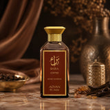 Soghaat Bara Coffee by Adyan Anfar 100ml Extrait de Parfum in a sleek glass bottle with a gold cap on a marble table.