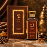 Soghaat Bara Coffee Extrait de Parfum bottle and box with coffee beans and incense on a marble surface.