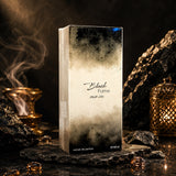 Soghaat Black Fume 100ml Extrait de Parfum box on a stone surface with incense smoke and a golden lantern background.