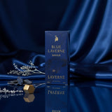 Blue Laverne Bakhur Eau de Parfum by Soghaat in a deep blue box, set against a draped blue satin background.