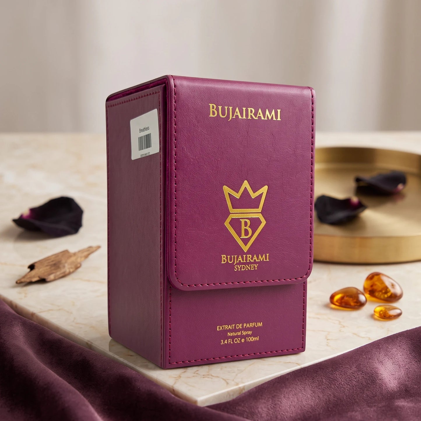 Soghaat Bujairami Breathless 100ml Extrait de Parfum in a deep purple leather-style case on a marble surface.