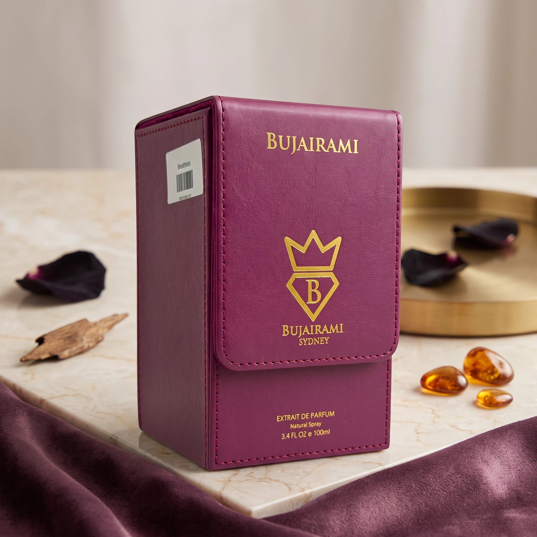 Soghaat Bujairami Breathless 100ml Extrait de Parfum in a deep purple leather-style case on a marble surface.