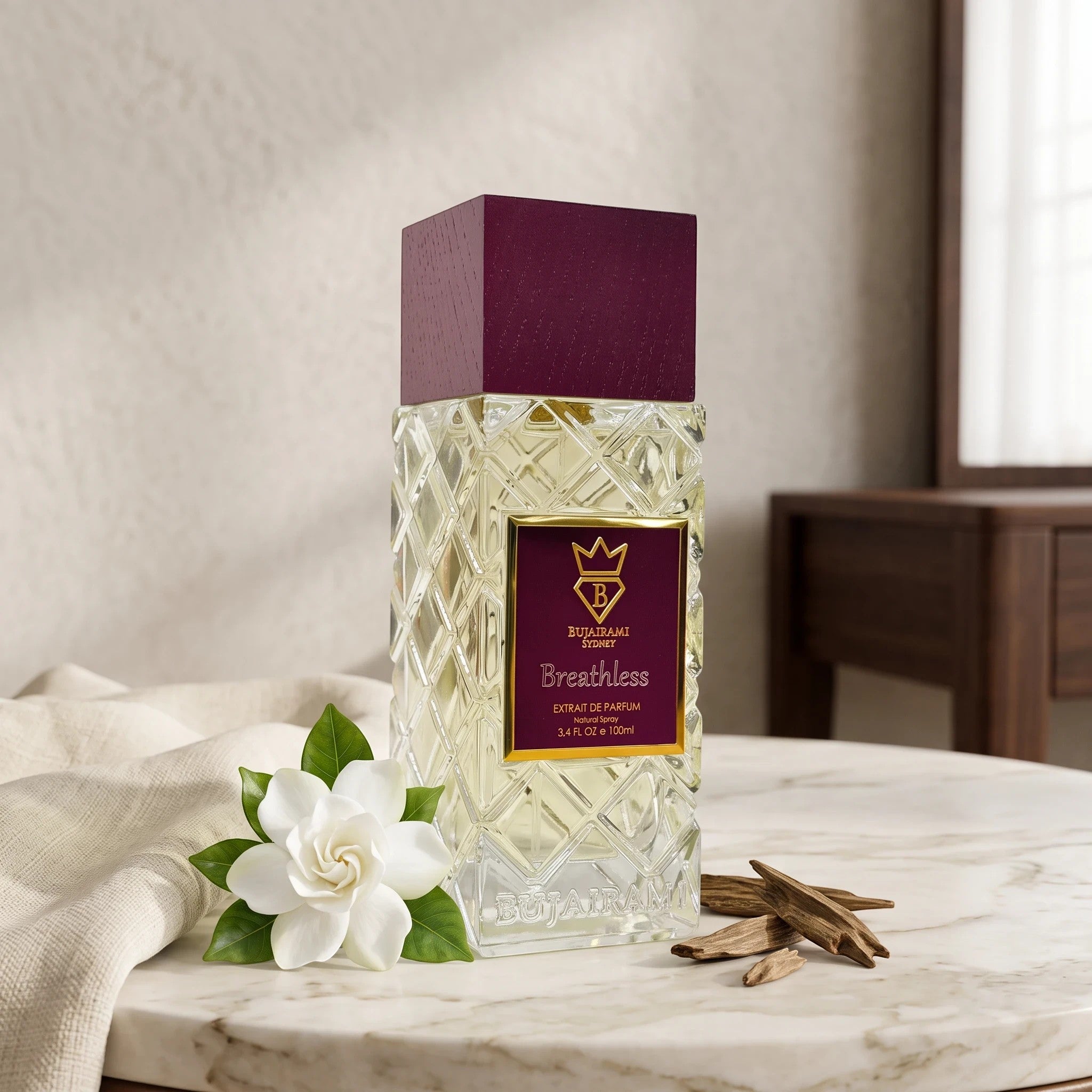 Soghaat Bujairami Breathless 100ml Extrait de Parfum bottle with a deep purple cap, white flower, and oud wood chips.