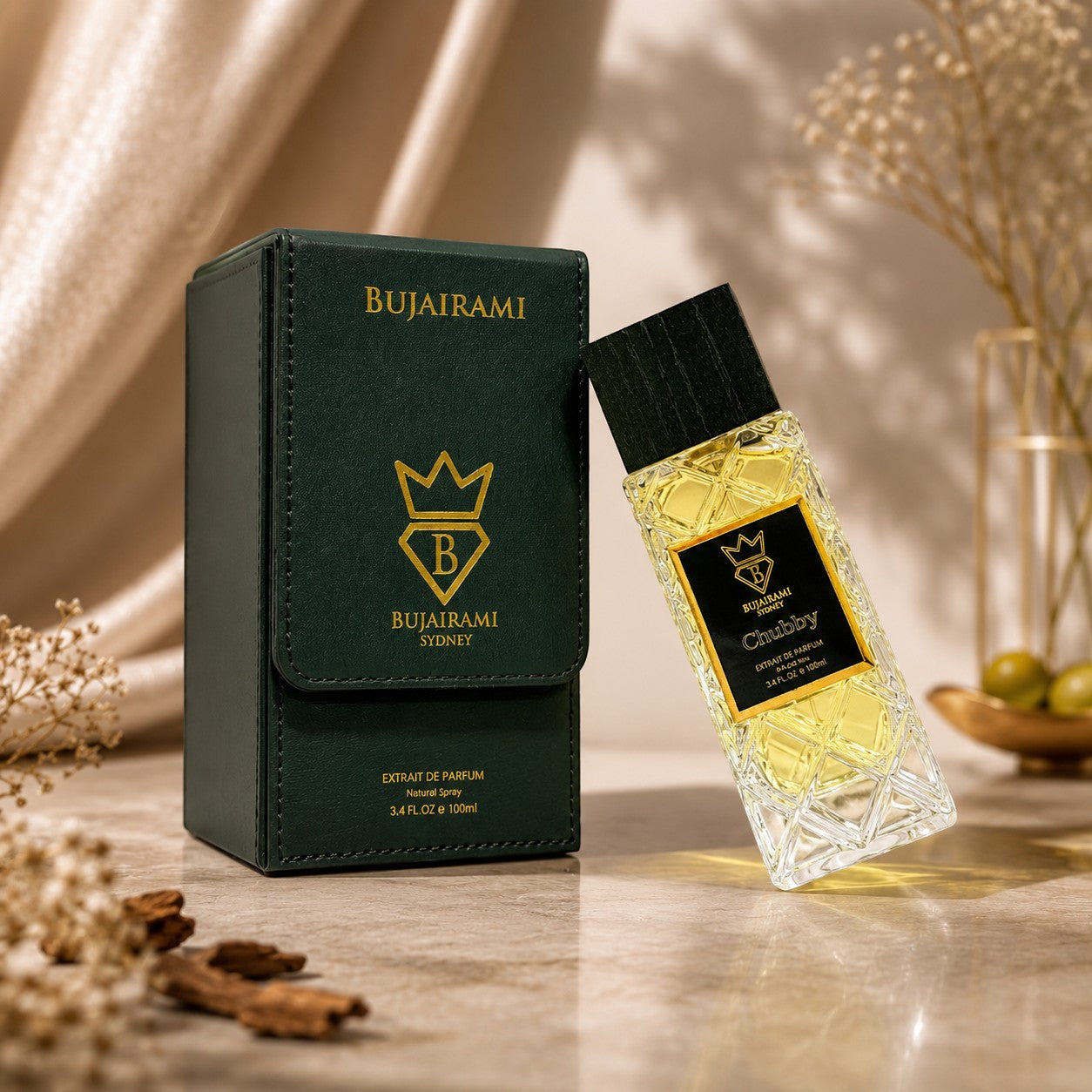 Bujairami Chubby 100ml Extrait de Parfum bottle and dark green presentation box with gold logo. Unisex fragrance.