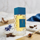 Soghaat Bujairami Deep Night 100ml Extrait de Parfum in a faceted glass bottle with a blue cap on a marble surface.