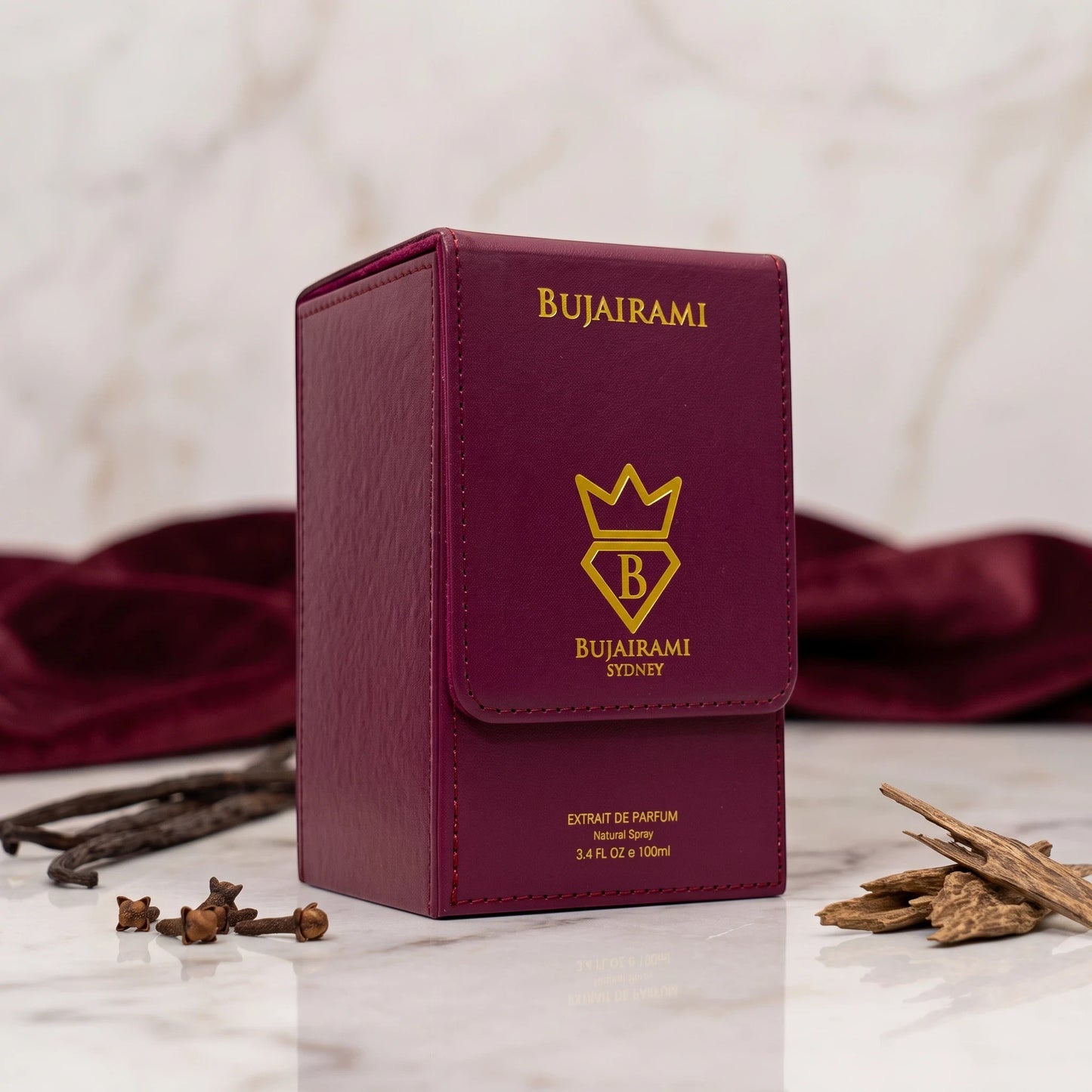 Soghaat Bujairami Dirty Money Extrait de Parfum in a deep purple leather-textured box with gold branding on marble.