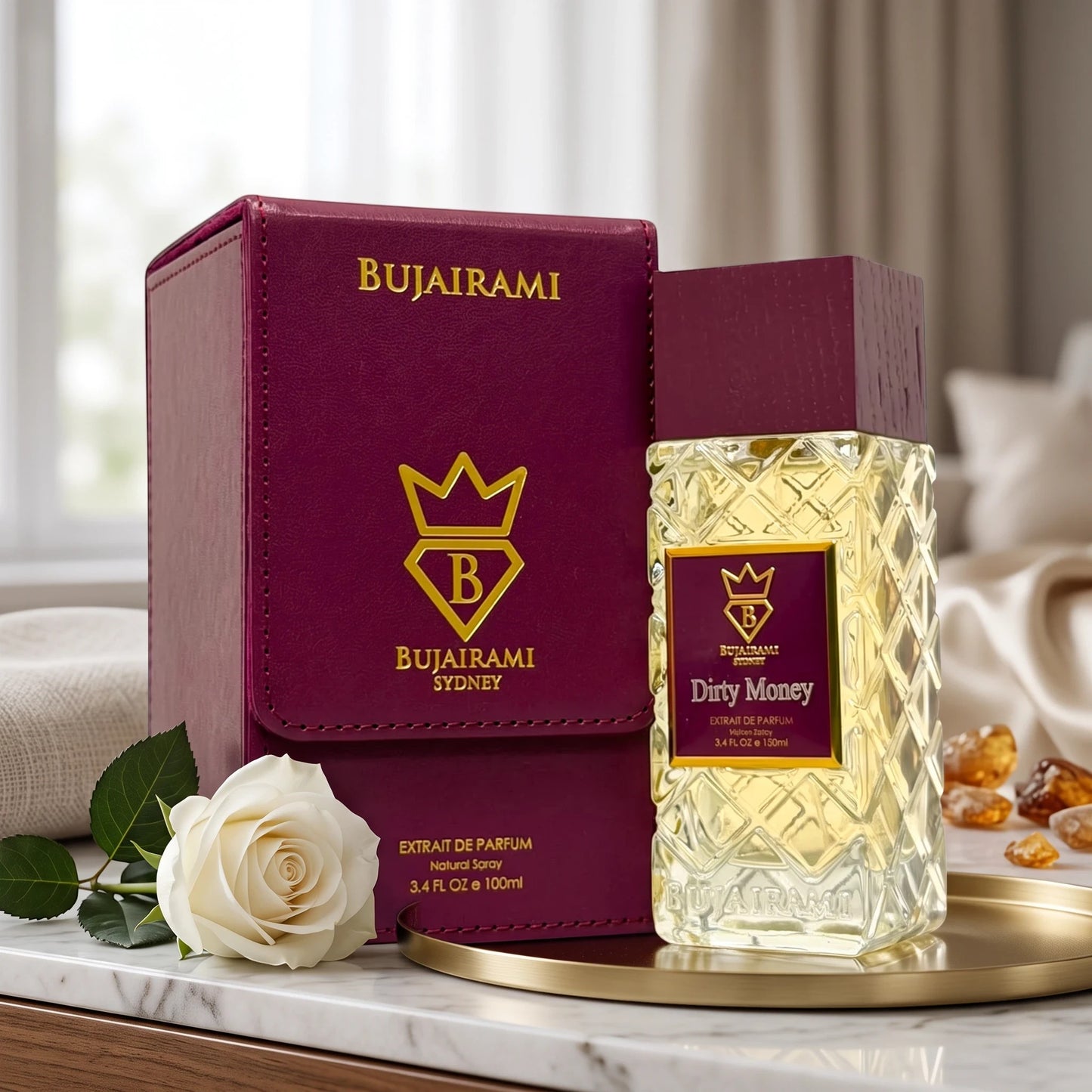 Soghaat Bujairami Dirty Money 100ml Extrait de Parfum bottle and leather case with a white rose on a marble surface.