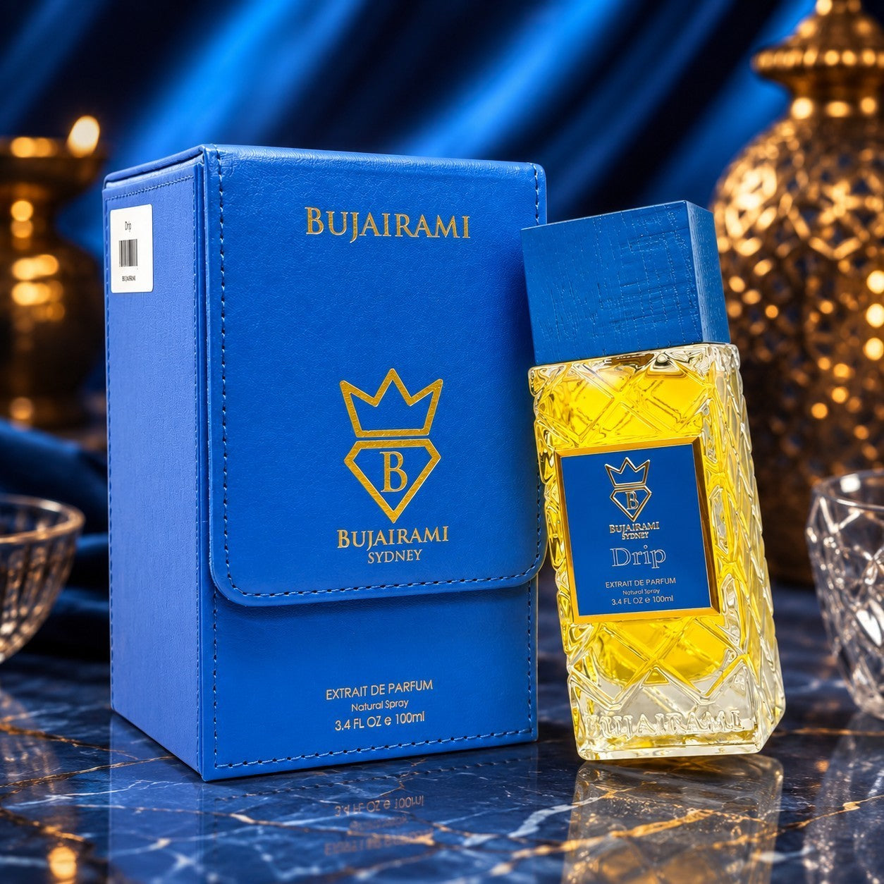 Soghaat Bujairami Drip 100ml Extrait de Parfum in a blue leather case and textured glass bottle on a marble surface.