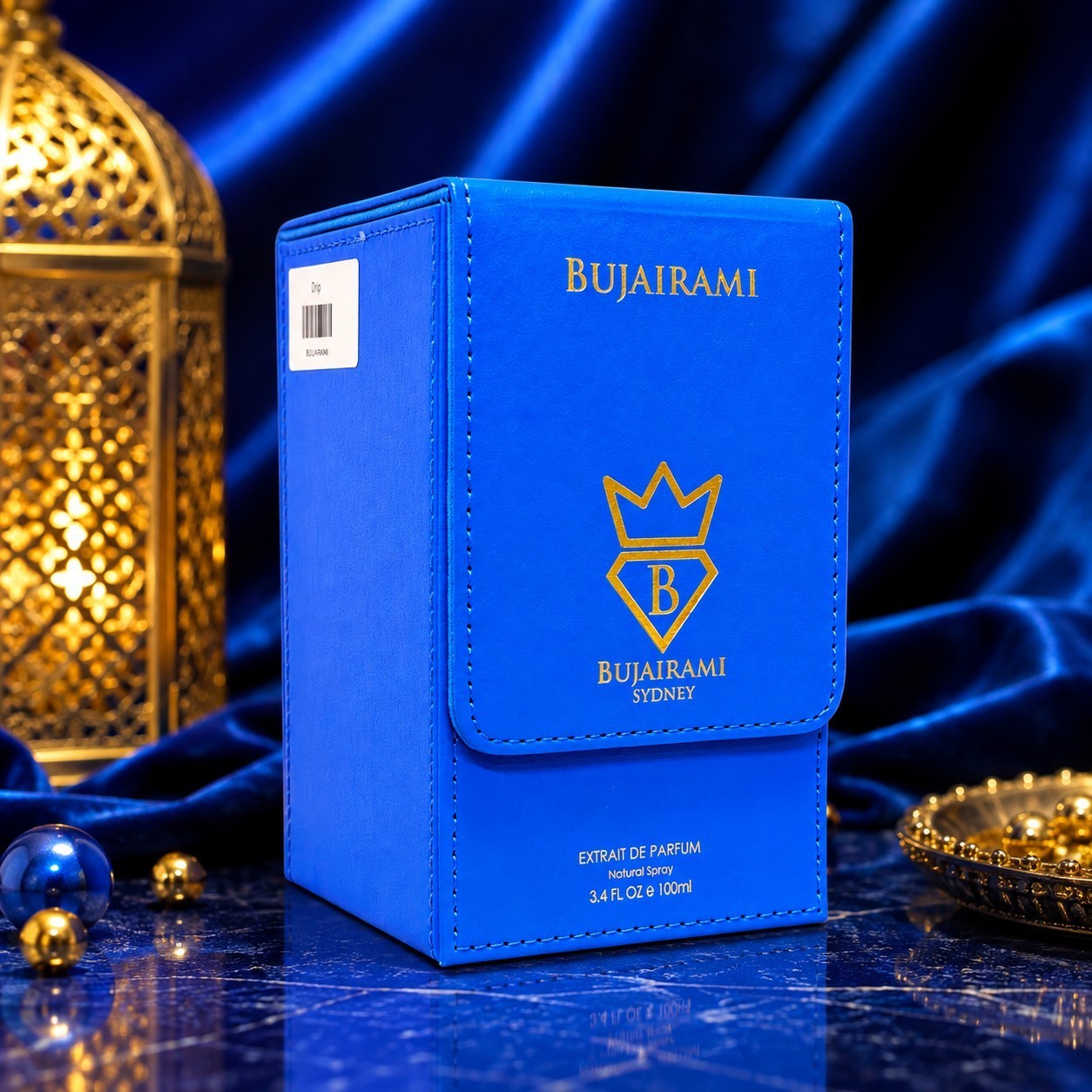 Soghaat Bujairami Drip 100ml Extrait de Parfum in a vibrant blue leather-style box against a blue velvet background.