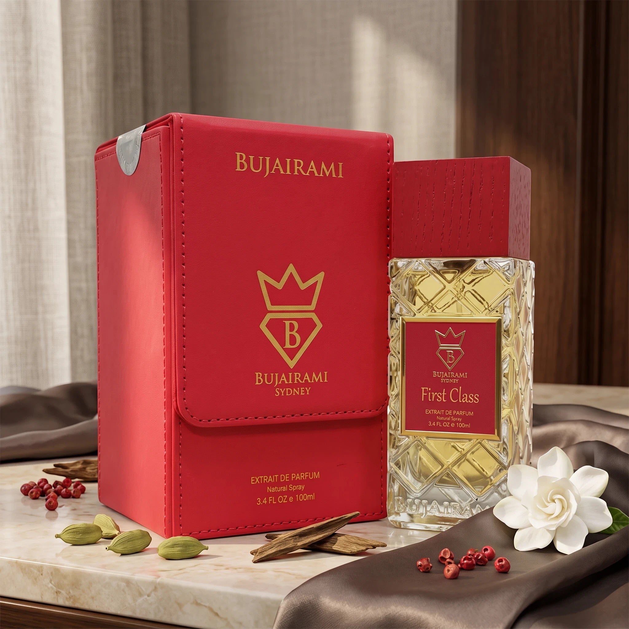 Soghaat Bujairami First Class Extrait de Parfum in a red leather box with a glass bottle on a marble surface.
