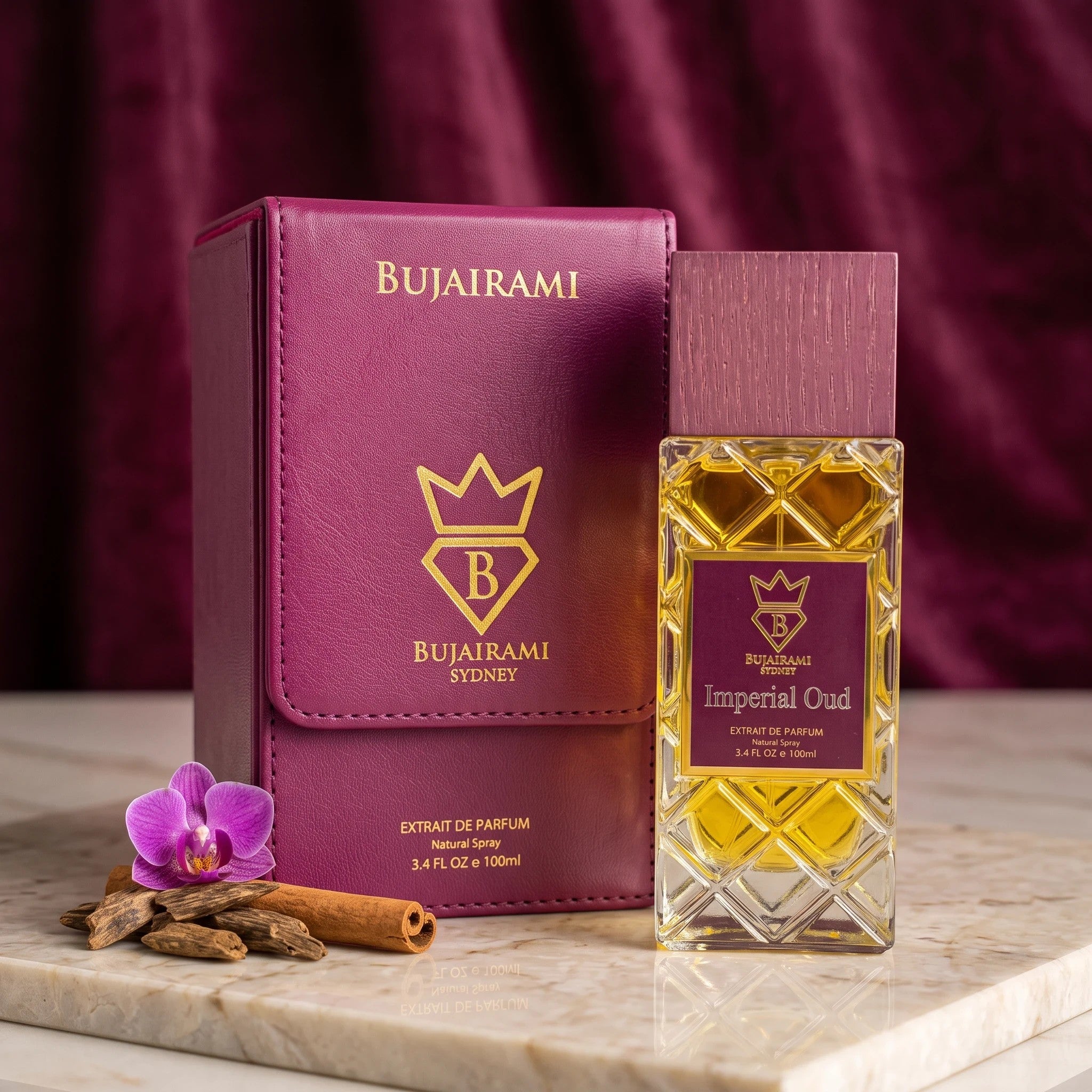 Soghaat Bujairami Imperial Oud Extrait de Parfum bottle and leather case with orchid and cinnamon on marble surface