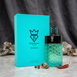 Soghaat Bujairami Inferno 100ml unisex Eau de Parfum bottle and turquoise box with honeycomb pattern on marble surface