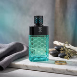 Soghaat Bujairami Inferno unisex Eau de Parfum in a teal glass bottle with a textured honeycomb pattern.