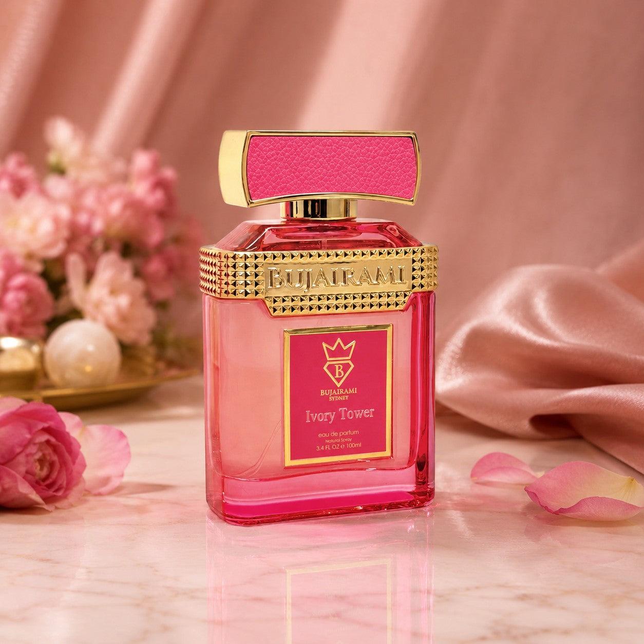 Soghaat Bujairami Ivory Tower Eau de Parfum in a vibrant pink glass bottle with gold accents and a textured cap.