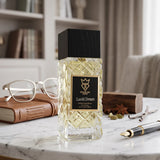 Soghaat Bujairami Lucid Dream 100ml Extrait de Parfum in a textured glass bottle on a marble desk with a fountain pen.