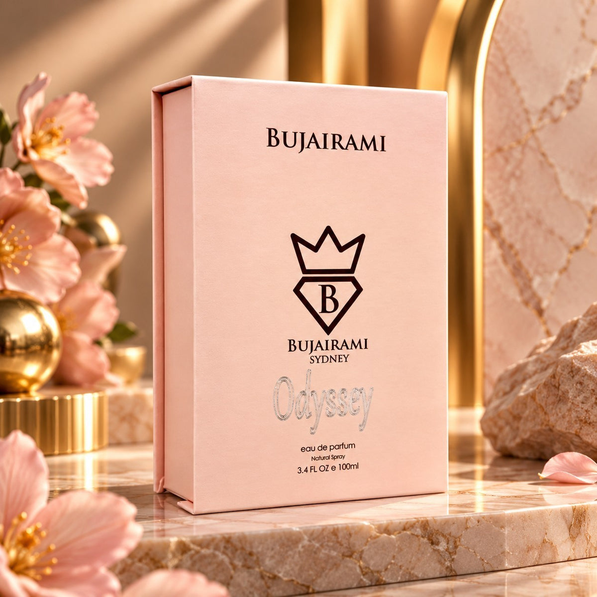 Soghaat Bujairami Odyssey 100ml Eau de Parfum in a soft pink box, displayed on a marble surface with floral accents.