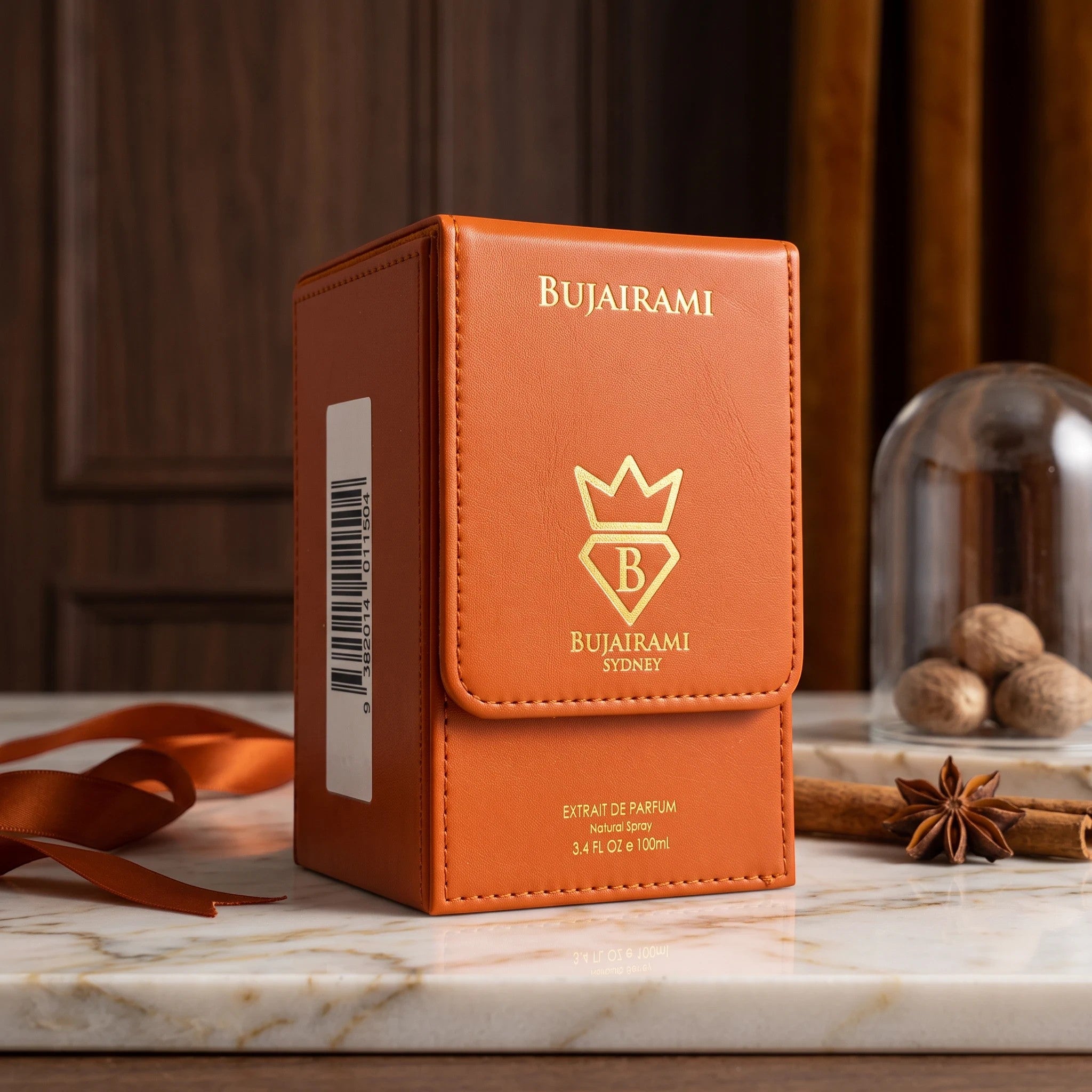 Soghaat Bujairami Oud Money Extrait de Parfum in a premium orange leather-textured box with gold branding.
