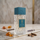 Soghaat Bujairami Real Deal 100ml Extrait de Parfum in a textured glass bottle with a teal wood cap on a marble surface.