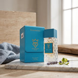 Soghaat Bujairami Real Deal unisex Extrait de Parfum bottle and blue leather case on a marble surface with lavender.