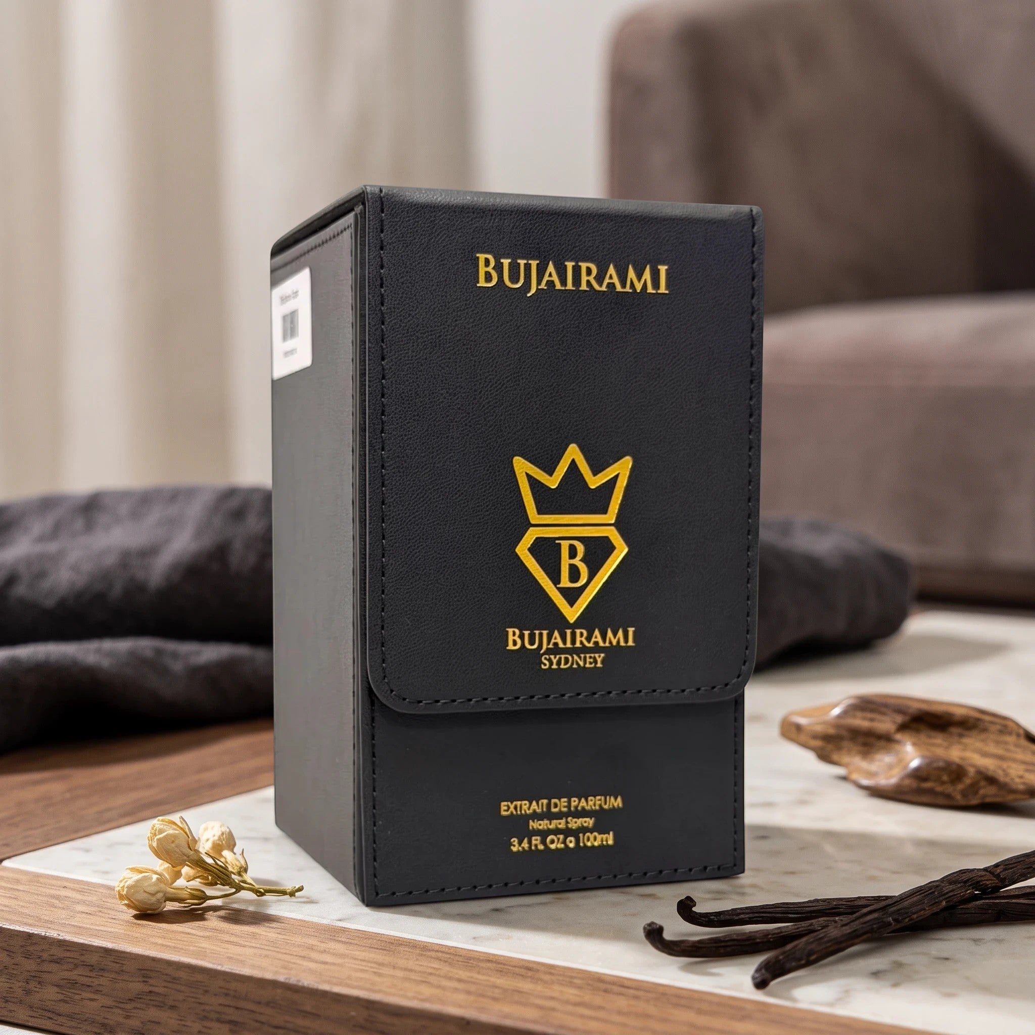 Soghaat Bujairami Shadow Script Extrait de Parfum in a black leather-textured box with gold branding on a marble table.
