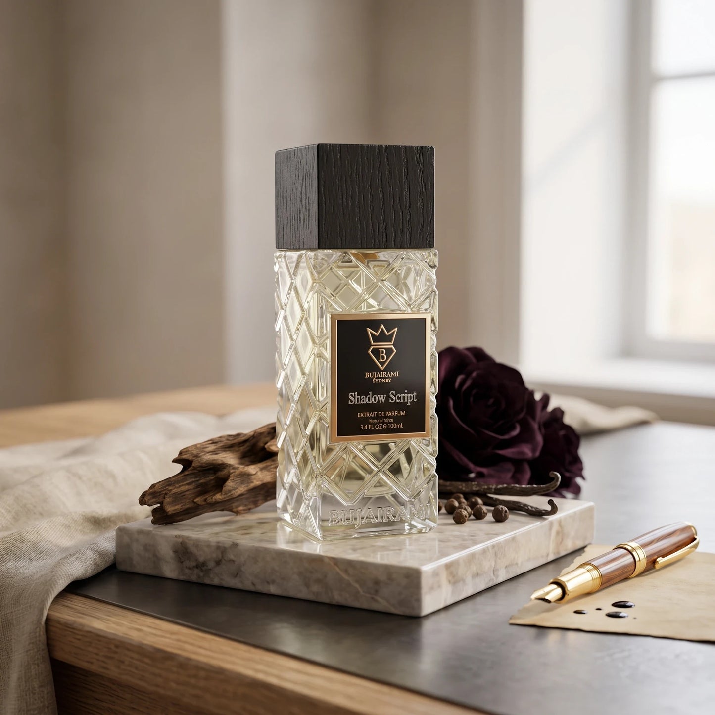 Soghaat Bujairami Shadow Script Extrait de Parfum bottle with a textured glass design and dark wood cap on marble.