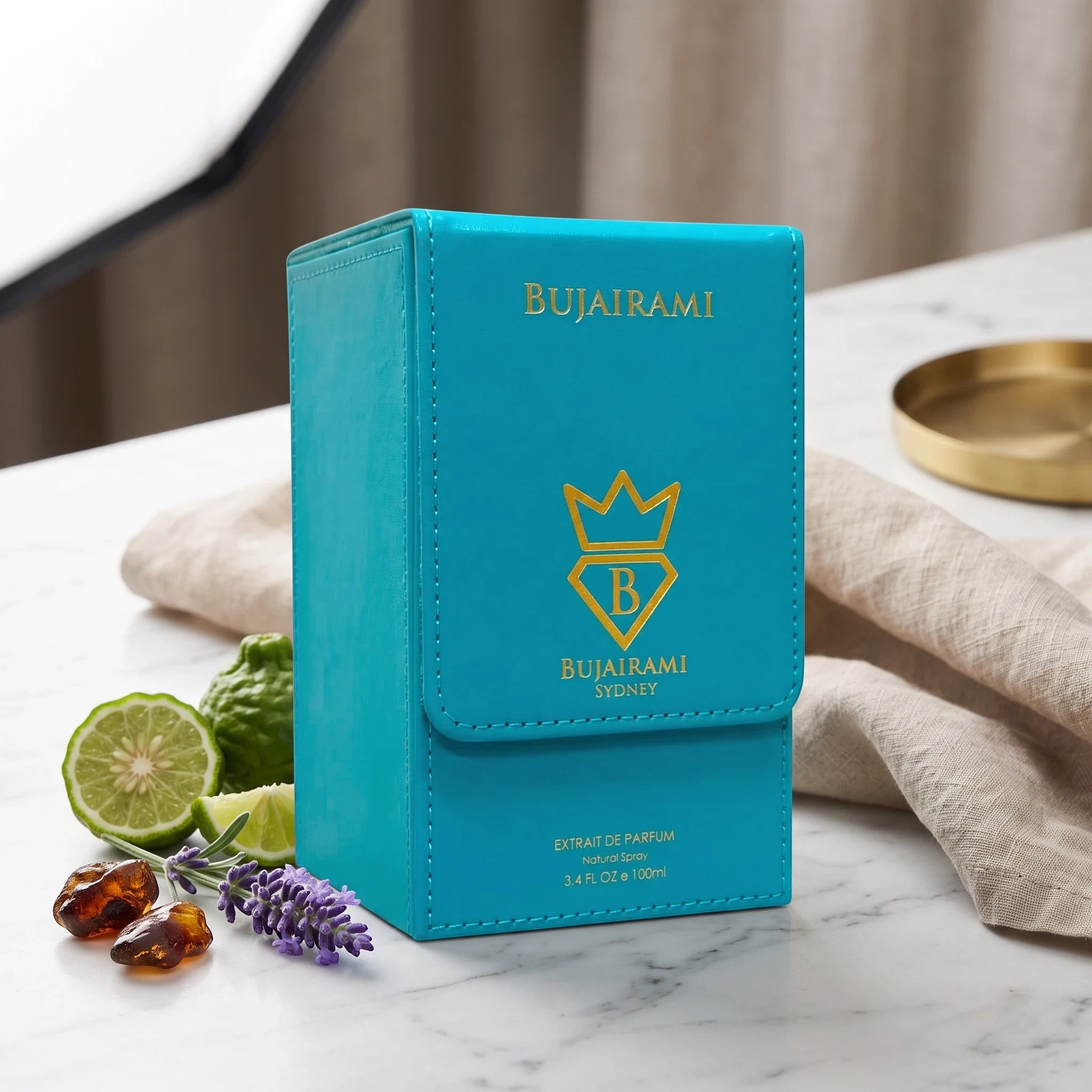 Soghaat Bujairami Sweet Escape 100ml Extrait de Parfum in a bright turquoise leather-style box on a marble surface.