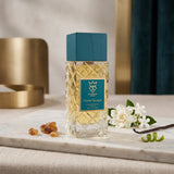 Soghaat Bujairami Sweet Escape Extrait de Parfum in a textured glass bottle with a teal cap on a marble surface.