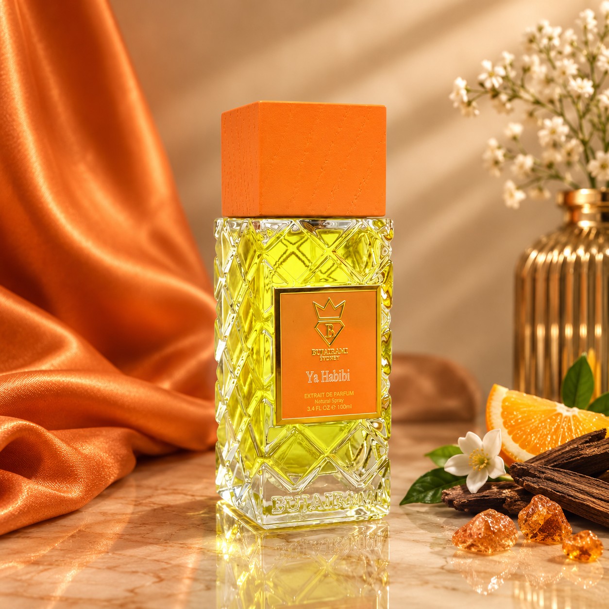 Soghaat Bujairami Ya Habibi Extrait de Parfum in a textured glass bottle with an orange cap, set against orange fabric.
