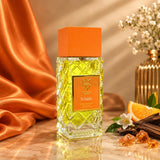 Soghaat Bujairami Ya Habibi Extrait de Parfum in a textured glass bottle with an orange cap, set against orange fabric.