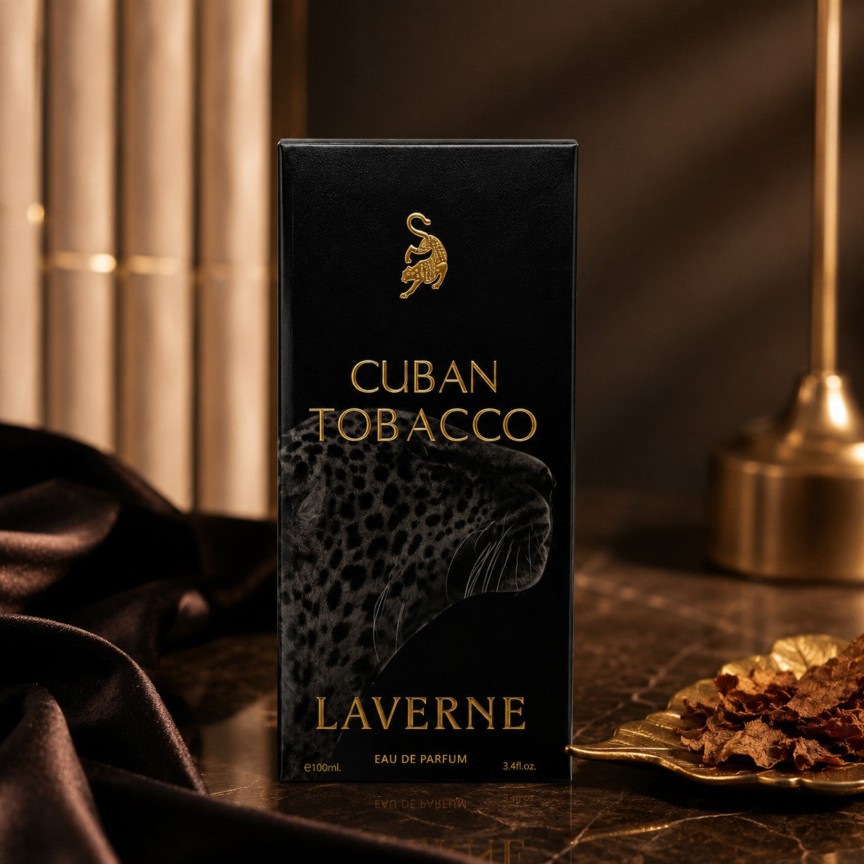 Soghaat Cuban Tobacco by Laverne 100ml Eau de Parfum in a black box with gold leopard emblem on a dark marble surface.