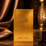 Soghaat Fragrance World Des Tentations Star 100ml gold perfume box on a reflective surface with warm ambient lighting.