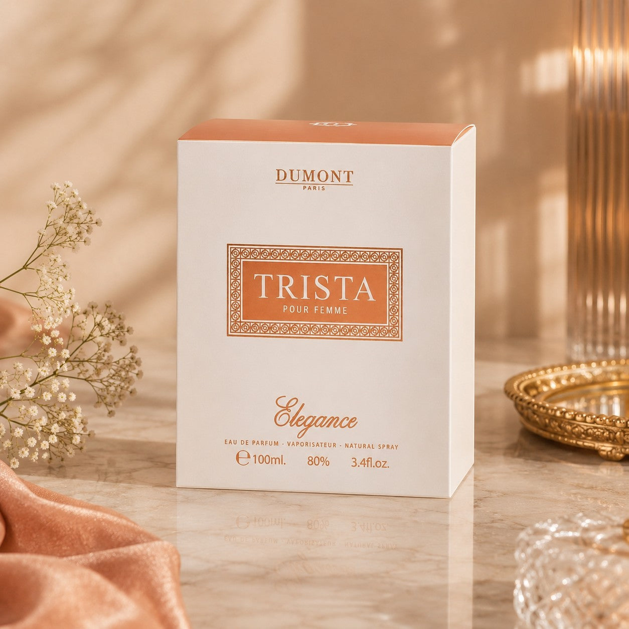 Soghaat Dumont Paris Trista Elegance 100ml Eau de Parfum box on a marble surface with soft lighting and floral decor.