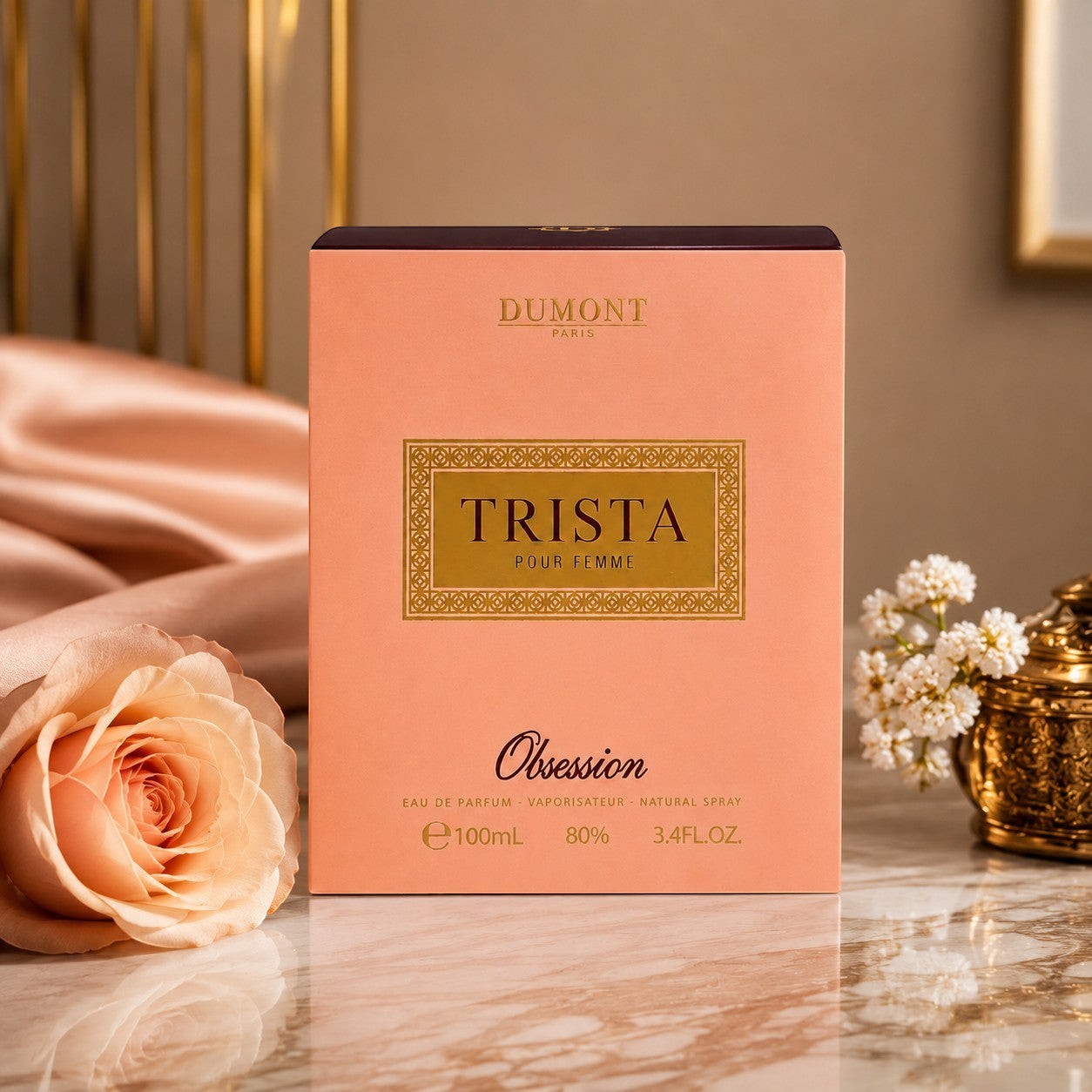 Soghaat Dumont Paris Trista Obsession 100ml Eau de Parfum box in peach with gold lettering on a marble surface.