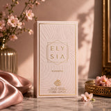 Soghaat Elysia Elegance 100ml Eau de Parfum bottle in a soft pink textured box with gold lettering on a marble surface.