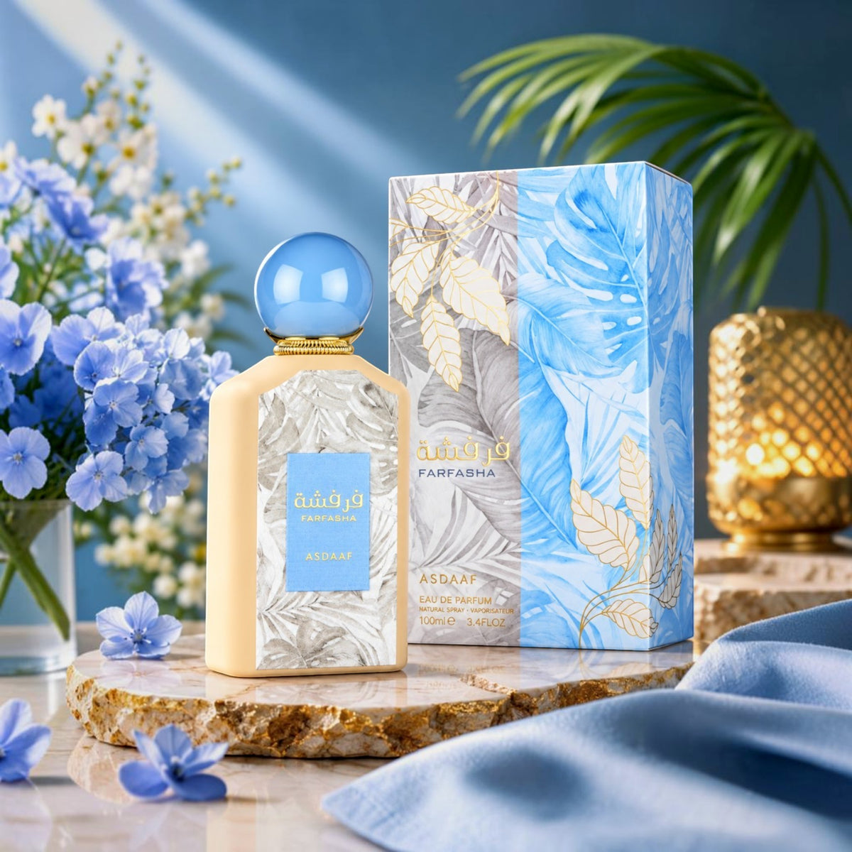 Soghaat Farfasha 100ml Eau de Parfum bottle and box with blue floral accents, set on a stone surface with blue flowers.